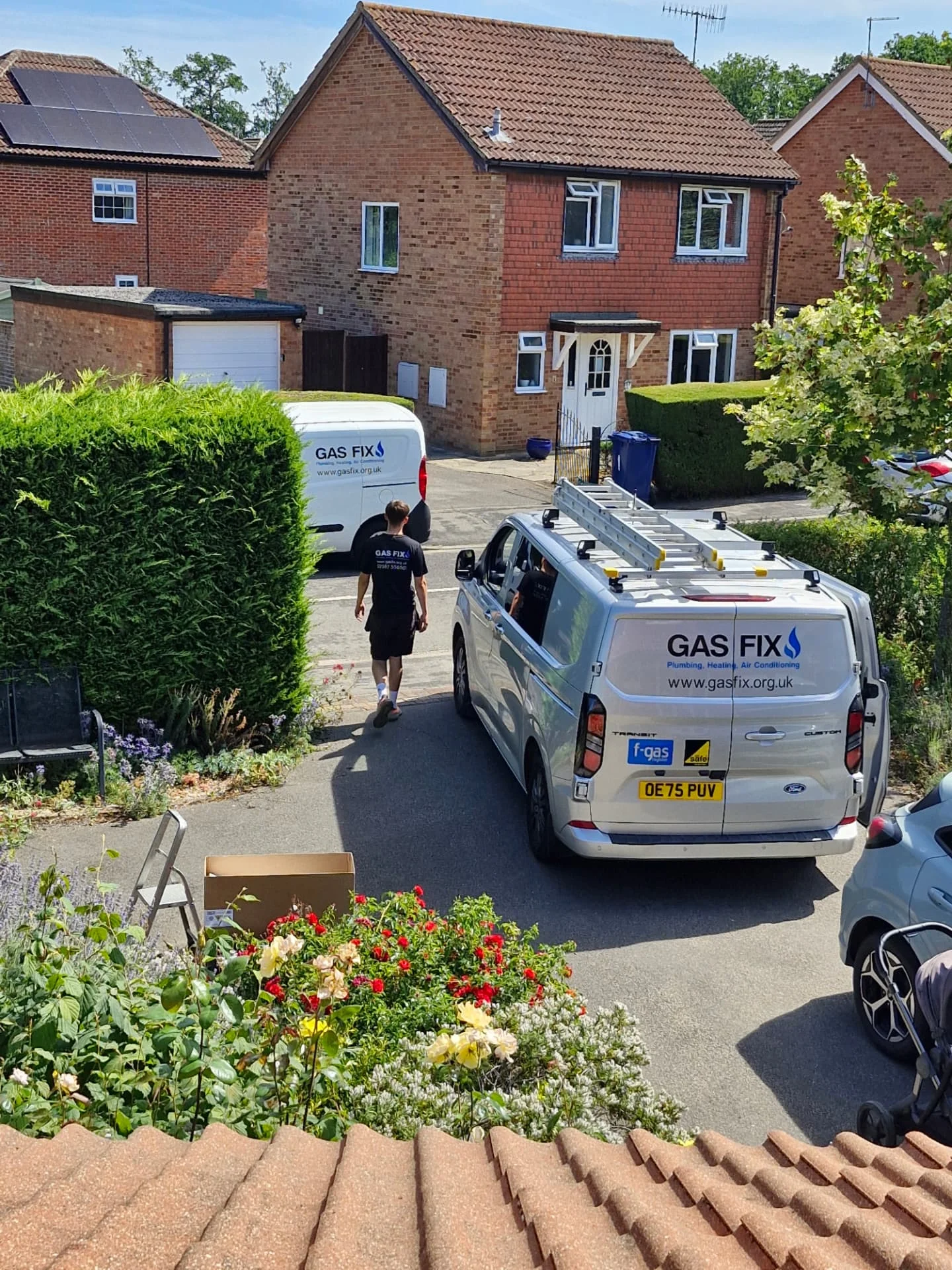 Two Gas Fix service vans on a residential job in Surrey with a Gas Fix engineer
