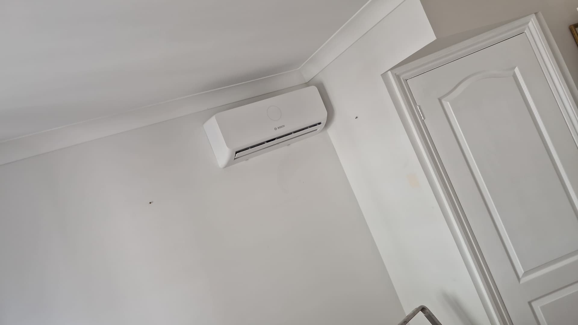 Wall-mounted Bosch air conditioning unit installed in a bedroom