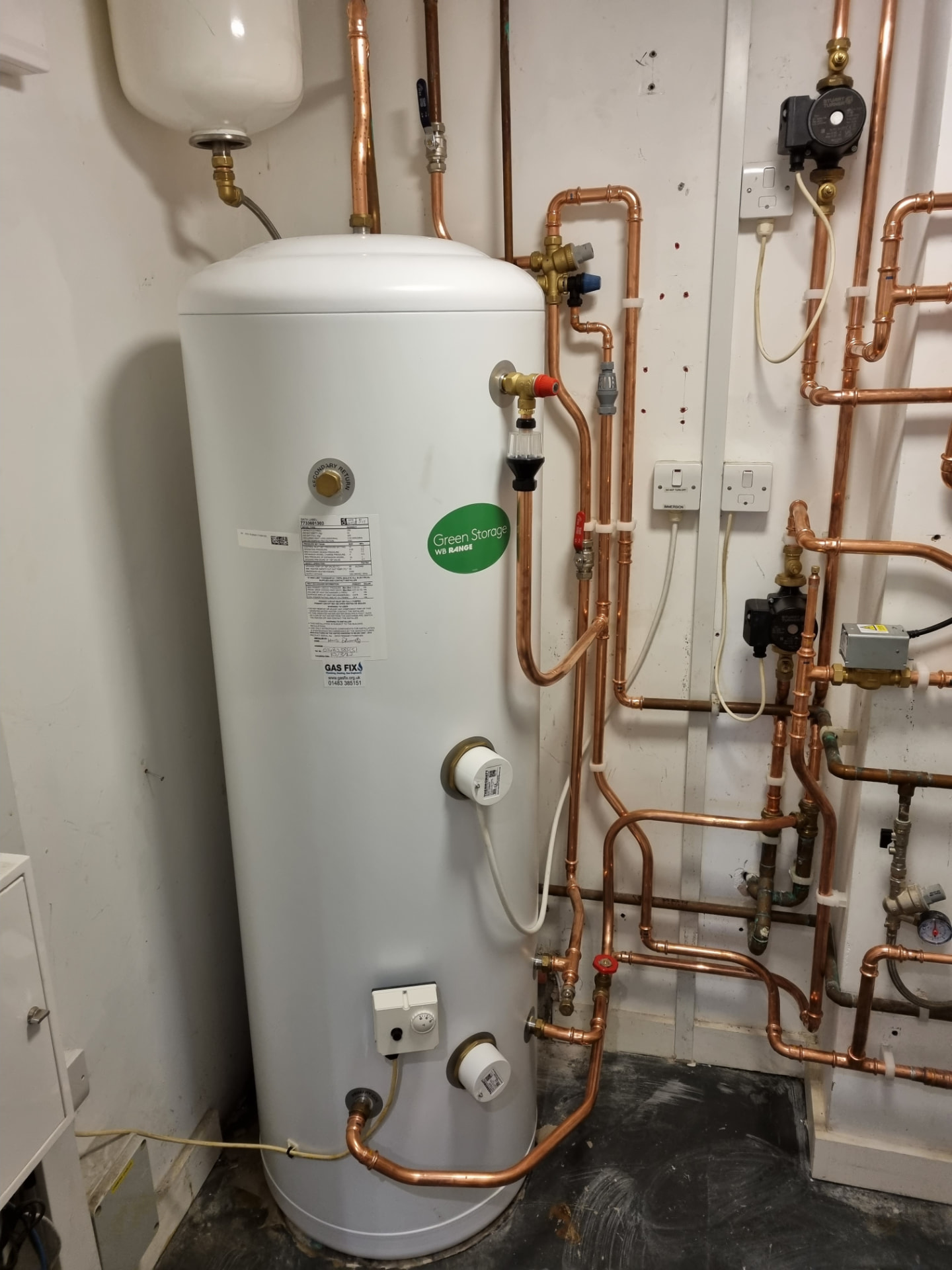 Unvented hot water cylinder with copper pipework and pumps