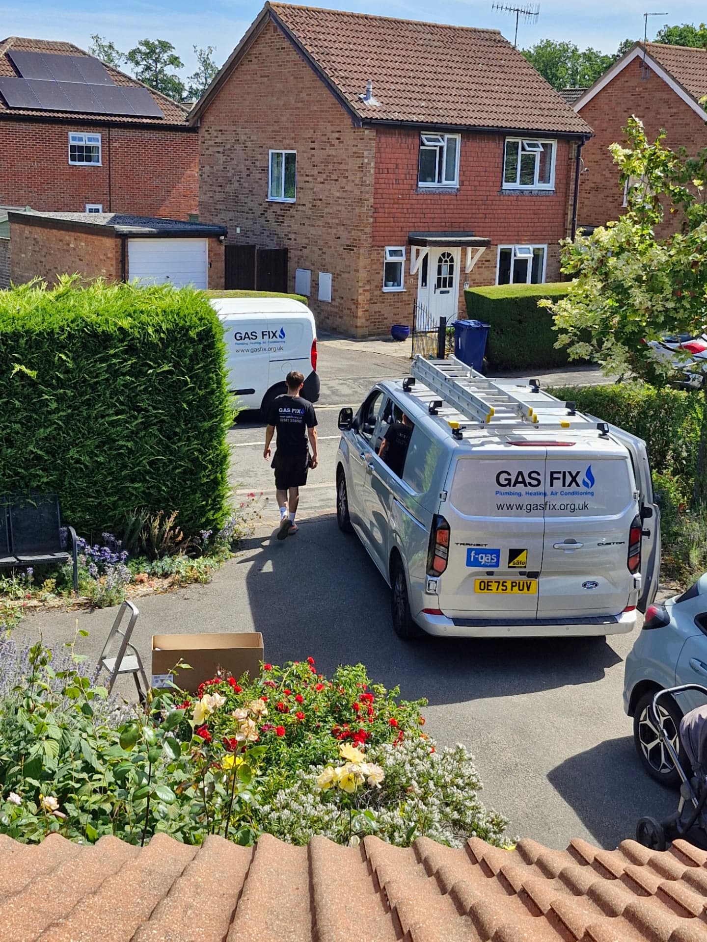 Two Gas Fix service vans on a residential job in Surrey with a Gas Fix engineer